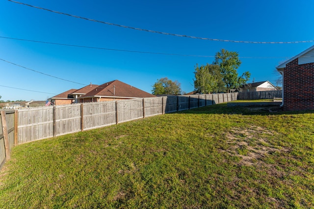 view of yard with a fenced backyard