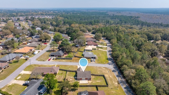 drone / aerial view featuring a residential view and a view of trees