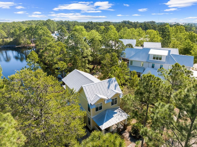birds eye view of property with a water view and a view of trees