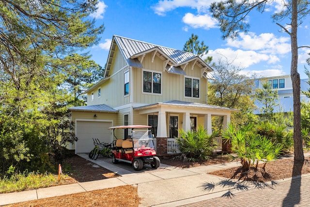 craftsman inspired home featuring metal roof, a porch, and a garage