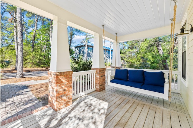 wooden terrace with a porch