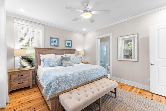 bedroom featuring crown molding, light wood finished floors, baseboards, a ceiling fan, and ensuite bath