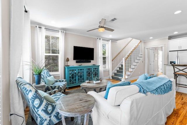 living room featuring crown molding, stairway, wood finished floors, ceiling fan, and recessed lighting