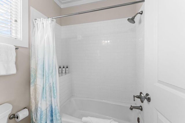bathroom with shower / bath combination with curtain and toilet