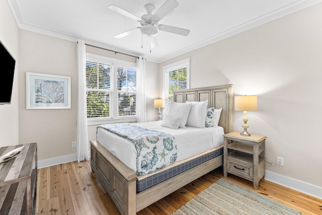 bedroom with ornamental molding, baseboards, and light wood-type flooring