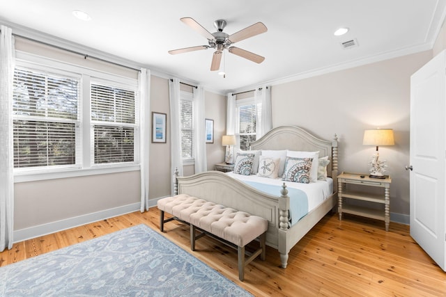 bedroom featuring light wood-type flooring, ornamental molding, baseboards, and visible vents