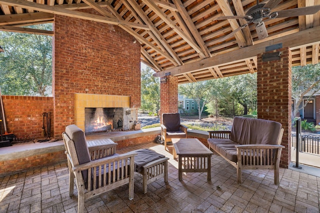 view of patio featuring an outdoor living space with a fireplace and ceiling fan