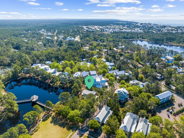 aerial view featuring a water view and a view of trees