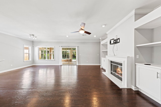 4397 Vardon Way, Niceville, FL 32578 - unfurnished living room featuring ceiling fan, a glass covered fireplace, hardwood / wood-style flooring, ornamental molding, and baseboards