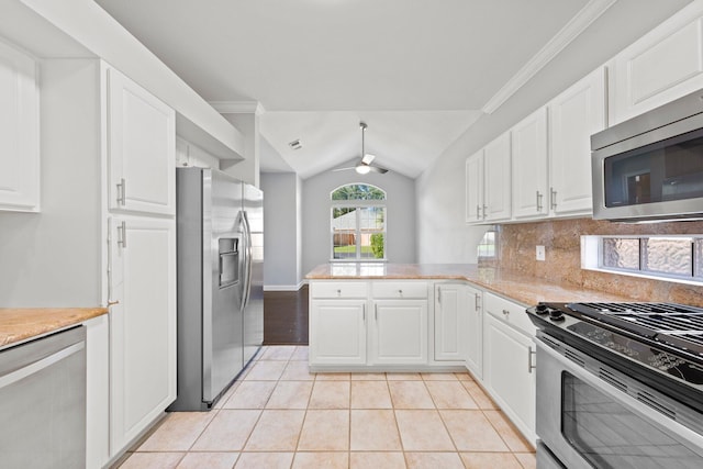 4397 Vardon Way, Niceville, FL 32578 - kitchen featuring appliances with stainless steel finishes, a ceiling fan, a peninsula, light tile patterned flooring, and white cabinets