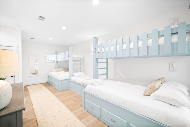bedroom featuring light wood-type flooring, recessed lighting, baseboards, and visible vents