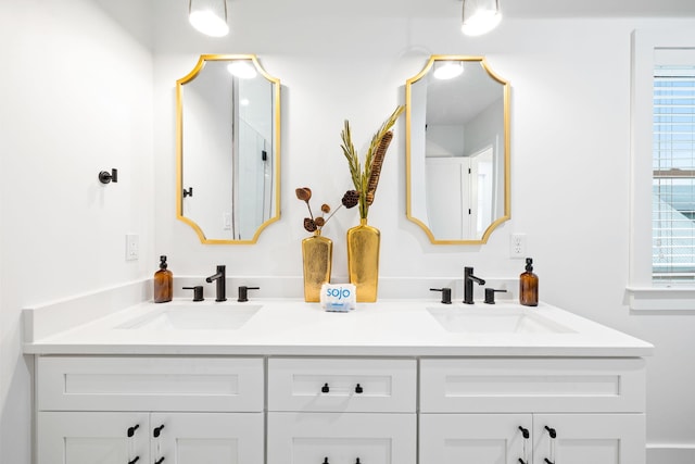 full bathroom featuring double vanity and a sink