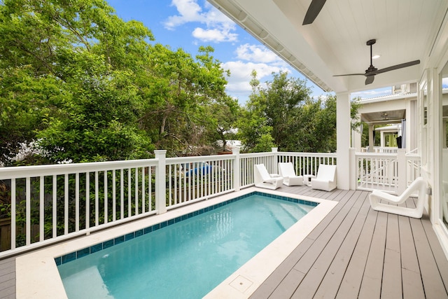 view of pool with ceiling fan and a deck