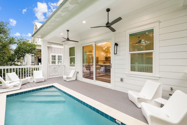 view of pool with a deck and ceiling fan