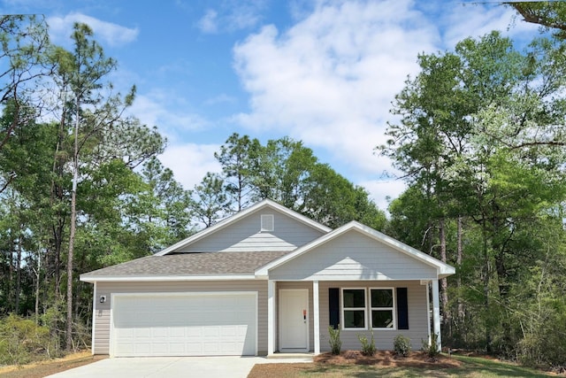 6005 Hidden Knoll Ct, Crestview, FL 32539 - view of front of home with an attached garage, concrete driveway, roof with shingles, and a porch