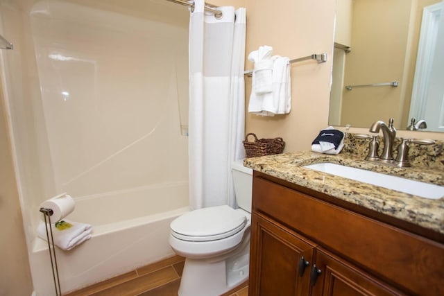 bathroom with toilet, shower / bath combo with shower curtain, and vanity