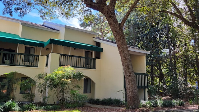 view of side of home with stucco siding