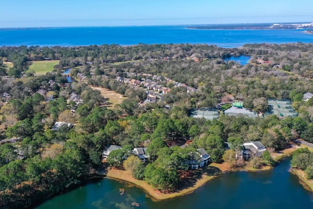 aerial view with a wooded view and a water view