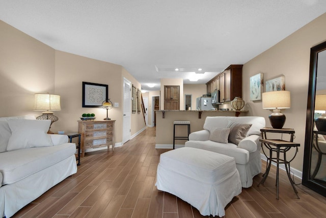living room featuring wood finish floors and baseboards