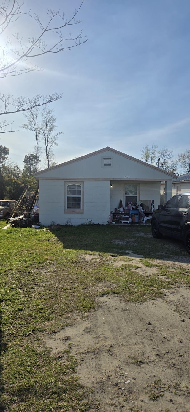 view of side of home featuring a yard