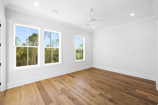 spare room featuring baseboards, visible vents, ornamental molding, and hardwood / wood-style floors