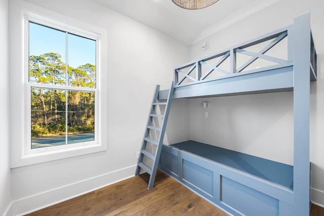 bedroom with baseboards and wood finished floors