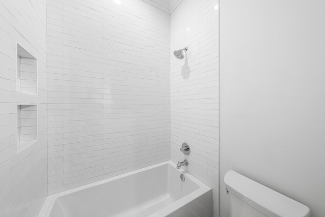 bathroom with bathtub / shower combination and toilet