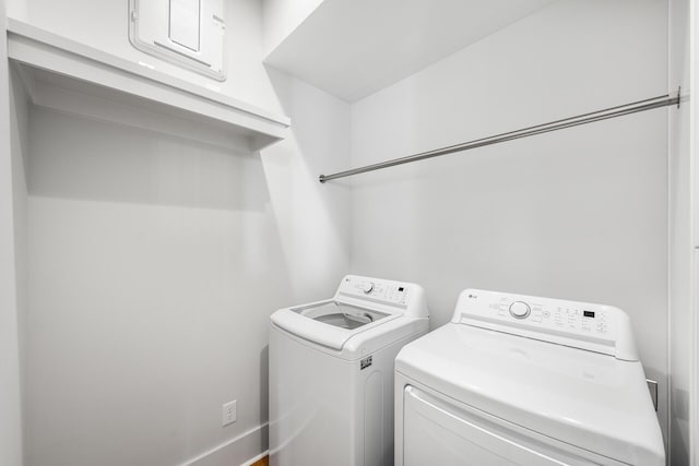 laundry room featuring washer and clothes dryer and cabinet space
