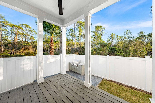 wooden deck featuring grilling area and fence