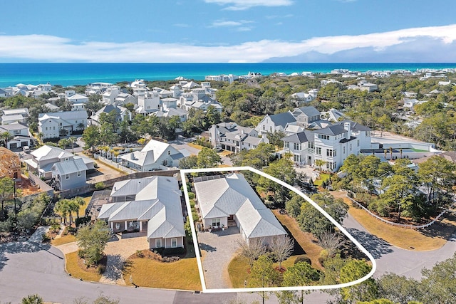 drone / aerial view with a residential view and a water view