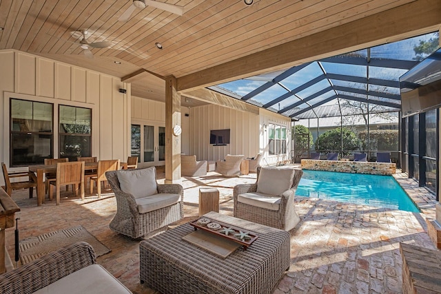 pool featuring outdoor lounge area, outdoor dining area, a patio, and glass enclosure