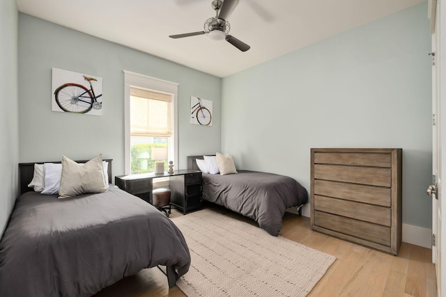 bedroom featuring light wood-type flooring and a ceiling fan