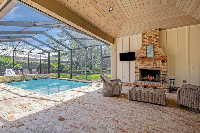 outdoor pool with an outdoor brick fireplace, glass enclosure, and a patio area