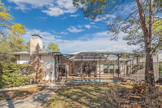 exterior space with a lanai, an outdoor pool, and a patio area