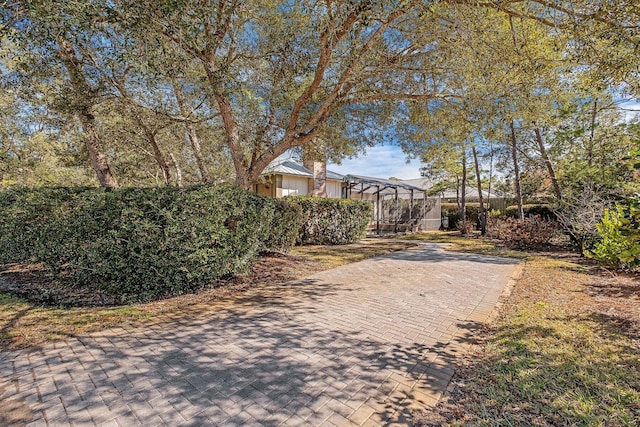 view of yard featuring glass enclosure and fence
