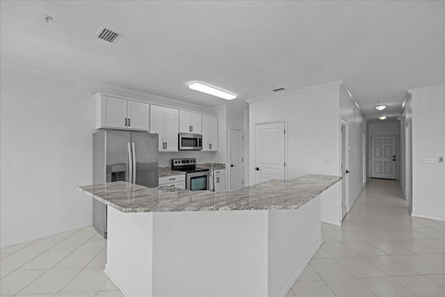 212 Harbor Blvd Unit 205, Destin, FL 32541 - kitchen with stainless steel appliances, light stone countertops, white cabinets, crown molding, and light tile patterned flooring