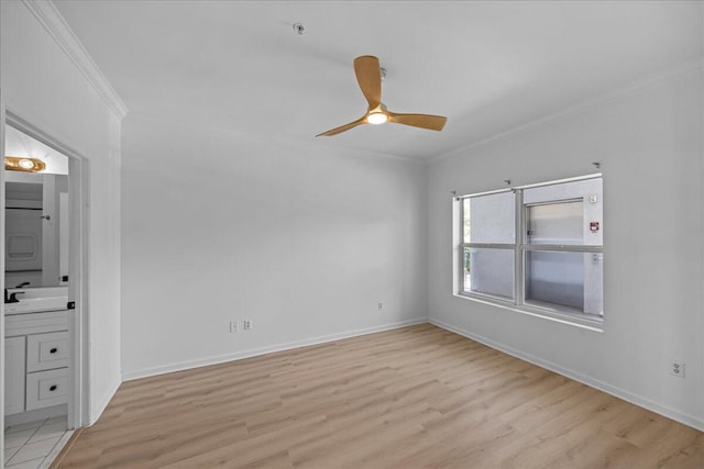 212 Harbor Blvd Unit 205, Destin, FL 32541 - spare room featuring ornamental molding, light wood-style floors, ceiling fan, baseboards, and a pendent fire sprinkler