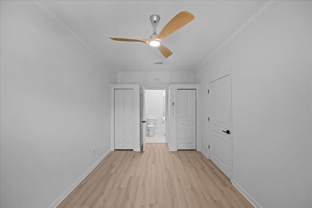 212 Harbor Blvd Unit 205, Destin, FL 32541 - unfurnished bedroom featuring light wood finished floors, crown molding, baseboards, connected bathroom, and ceiling fan