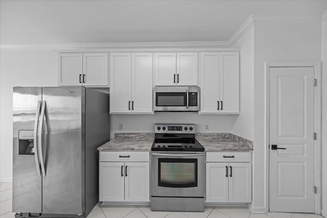 212 Harbor Blvd Unit 205, Destin, FL 32541 - kitchen with appliances with stainless steel finishes, white cabinets, light stone countertops, ornamental molding, and light tile patterned flooring