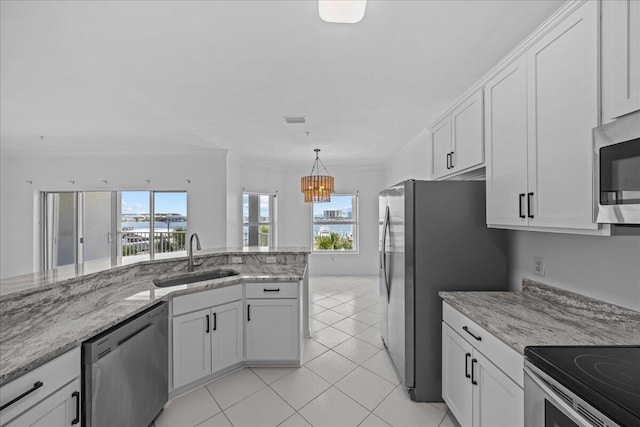 212 Harbor Blvd Unit 205, Destin, FL 32541 - kitchen with a sink, stainless steel appliances, healthy amount of natural light, a chandelier, and crown molding