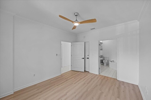 212 Harbor Blvd Unit 205, Destin, FL 32541 - unfurnished bedroom featuring wood finished floors, crown molding, ensuite bathroom, baseboards, and ceiling fan