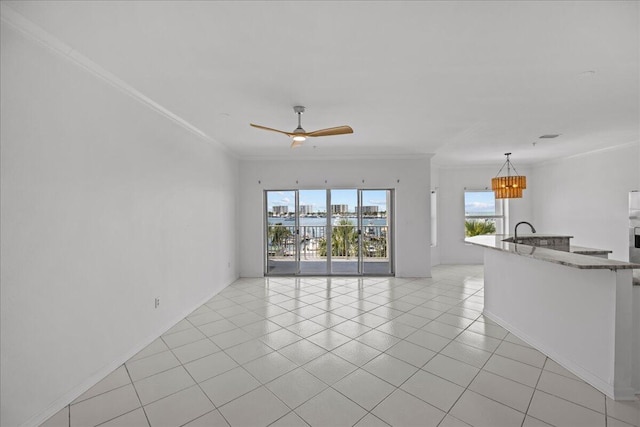 212 Harbor Blvd Unit 205, Destin, FL 32541 - unfurnished living room featuring ornamental molding, a chandelier, ceiling fan, and light tile patterned flooring