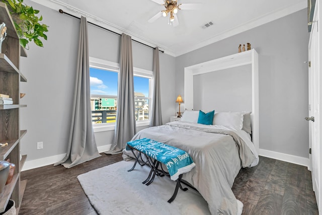 bedroom with wood finished floors, ornamental molding, ceiling fan, baseboards, and visible vents