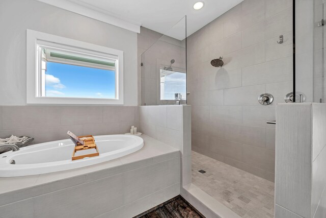 bathroom with walk in shower and a bath