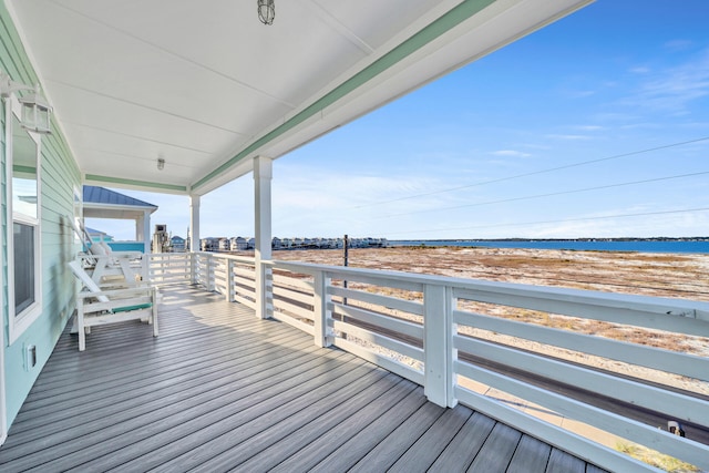 wooden deck featuring a water view