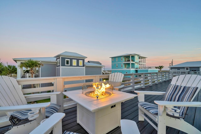 deck at dusk with an outdoor fire pit