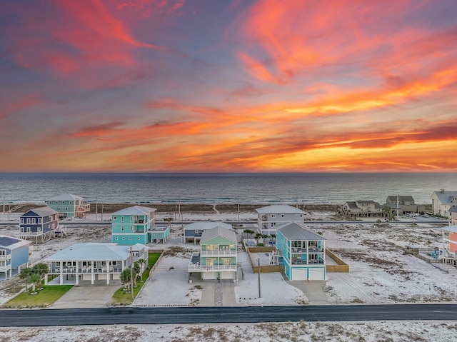 aerial view at dusk with a water view