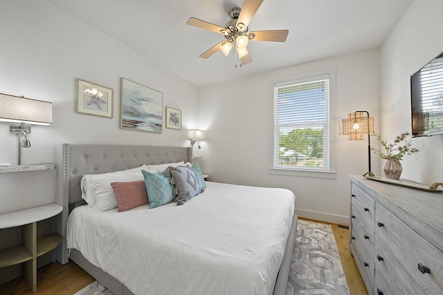 54 Dune Dr, Santa Rosa Beach, FL 32459 - bedroom with baseboards, light wood-style flooring, and ceiling fan