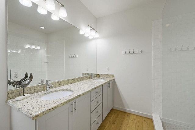 54 Dune Dr, Santa Rosa Beach, FL 32459 - bathroom featuring baseboards, double vanity, a sink, and wood finished floors
