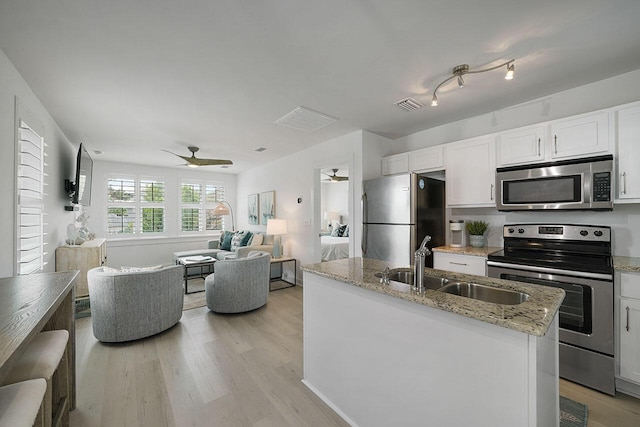 54 Dune Dr, Santa Rosa Beach, FL 32459 - kitchen featuring visible vents, a ceiling fan, appliances with stainless steel finishes, a sink, and light wood-type flooring
